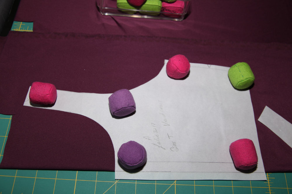 Pattern layed out on fabric weighted down