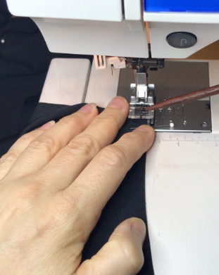 Image of fabric in sewing machine, showing one of many sewing machine basics.
